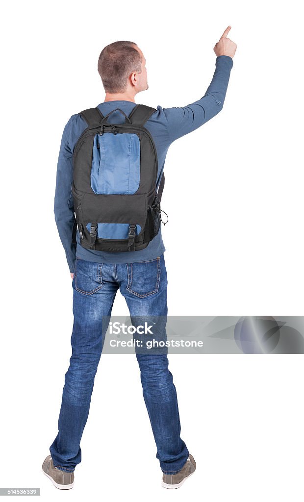 Back view of  pointing man with backpack looking up. Back view of  pointing man with backpack looking up. Standing young guy. Rear view people collection.  backside view of person. Isolated over white background. Adult Stock Photo