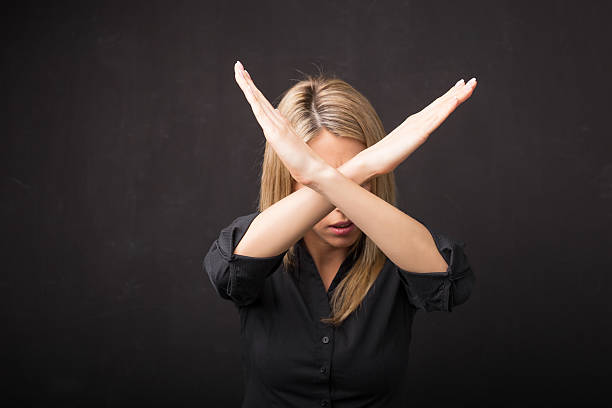 Woman showing x sign with her hands Woman showing x sign with her hands single word no stock pictures, royalty-free photos & images