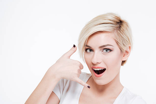 istock Pretty woman showing a call me gesture 514554810