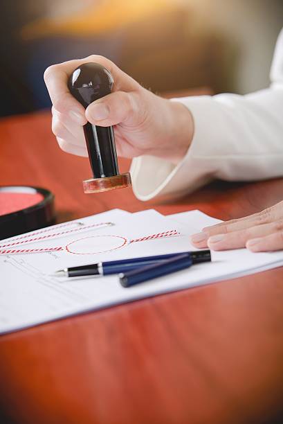 istock Woman Notary Public stamping the document 514556932
