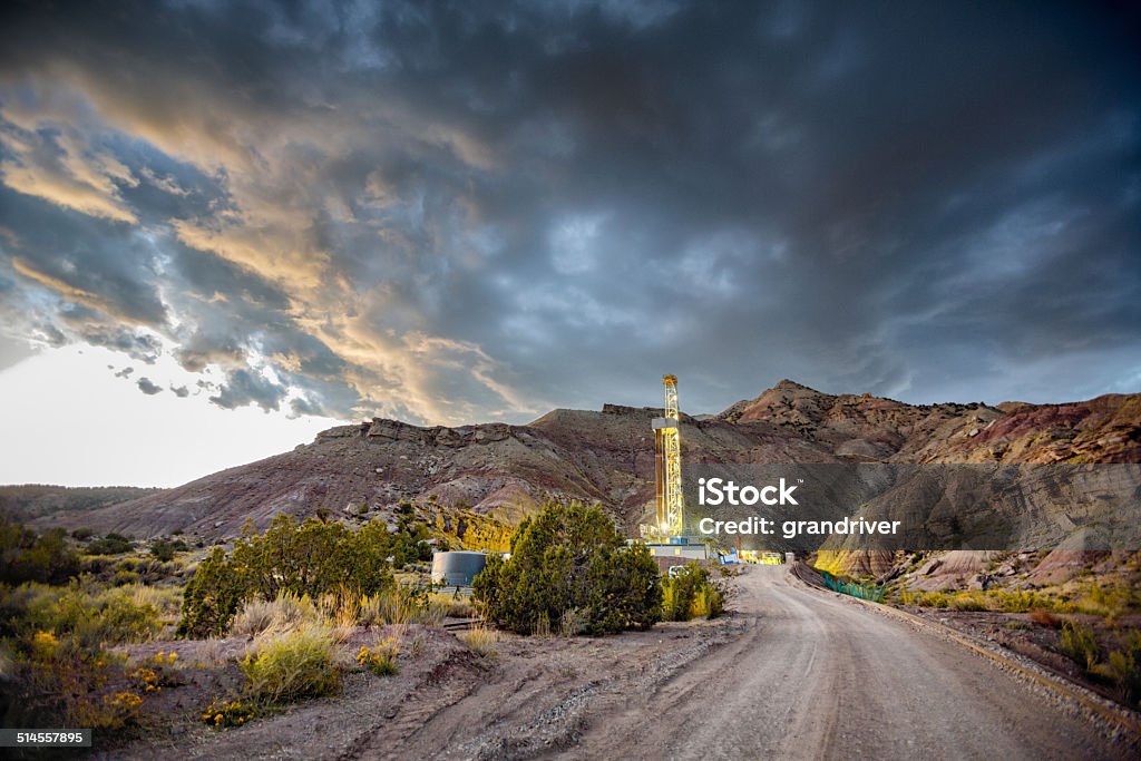 Drilling Fracking Rig at Sunrise Fracking Drill Rig under a dramatic sky at sunriseFracking Oil Well is conducting a fracking procedure to release trapped crude oil and natural gas to be refined and used as energy Fracking Stock Photo