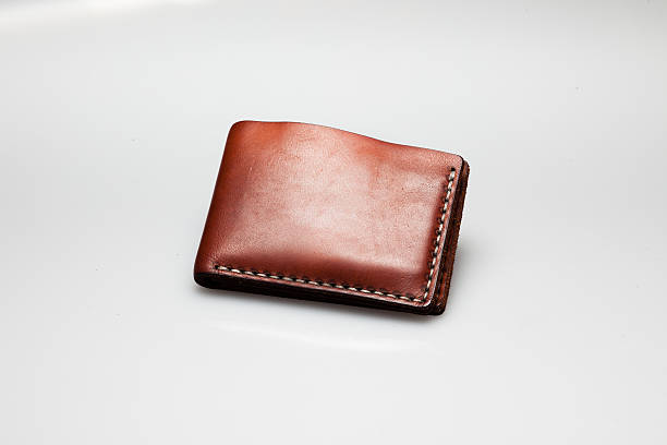 istock brown leather wallet on white, close up 514557981