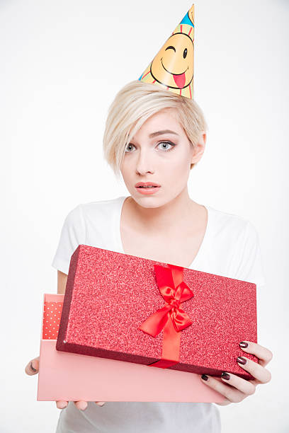 istock Attractive woman in party hat opening gift box 514558542