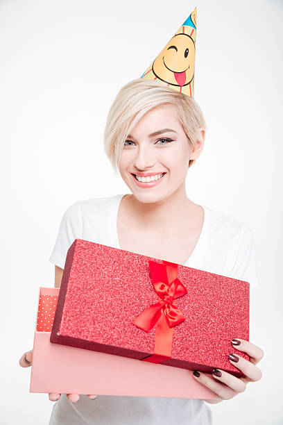 istock Happy woman in party hat opening gift box 514558650