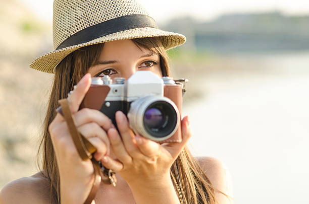 istock Young woman taking photos at the beach 514559073