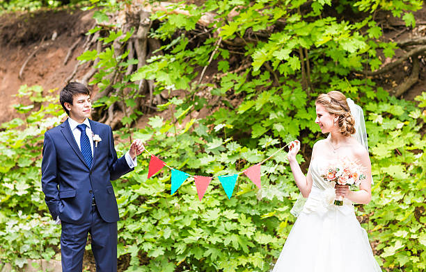 istock Bride and groom in the park. Garlands decorations 514559078
