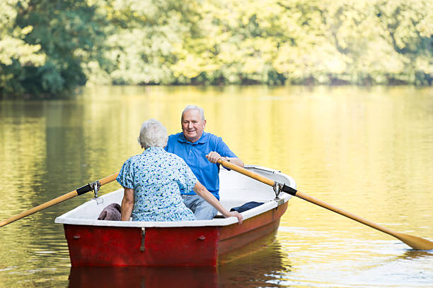 istock Happy senior couple rowing a boat on lake 514559215