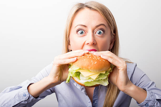 istock Woman eating burger 514559874