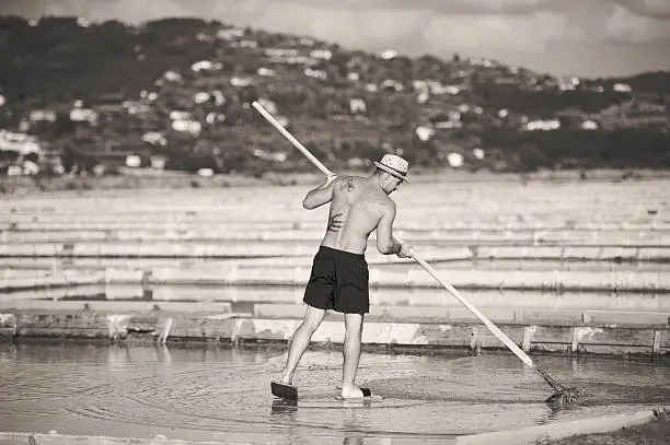 Manual worker at salt pans in Sečovlje, Portorse, Slovenia, Adriatic coast. Black and white image. Toned image.