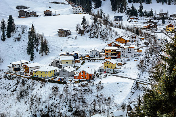 Winter village with colourful cottages in suburb of Ischgl, Austria. Winter tourism is very attractive in Ischgl. Nice modern place for vacation and rest. This is small colourful village in suburb. Photography is taken from Kapl Dorf. winter village austria tirol stock pictures, royalty-free photos & images