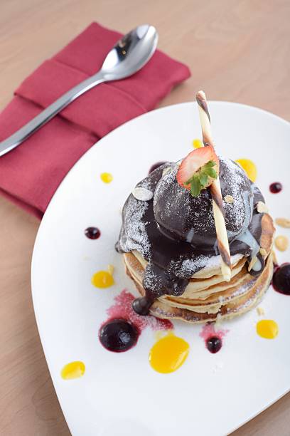 istock Stack of three chocolate pancakes with topping of chocolate ice cream 514560610