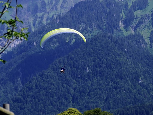 istock paragliding, parachute over the mountain 514562783