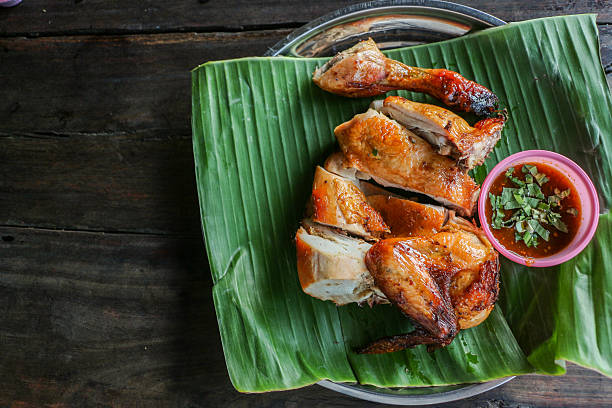 istock Grilled chicken with chili sauce on banana leaf 514563352