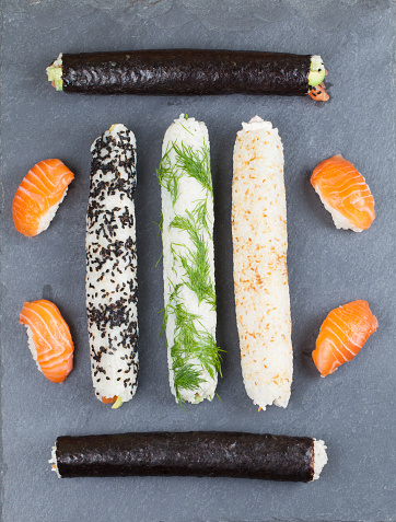 Homemade sushi rolls on a slate board