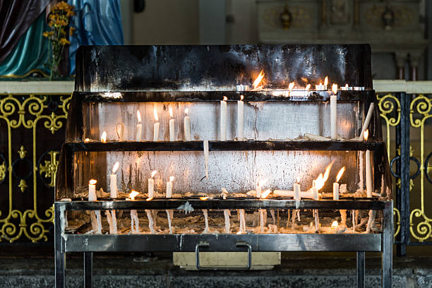 istock Candles station with burning candles within Catholic church 514564786