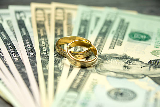 istock Wedding rings and cash 514564862