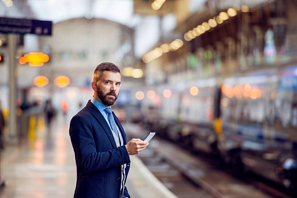 istock Hipster businessman with smartphone, waiting, train platform 514564910