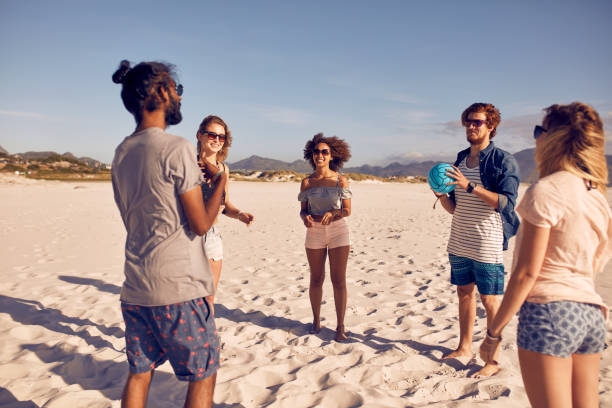 istock Group of friends on the beach playing with ball 514565076