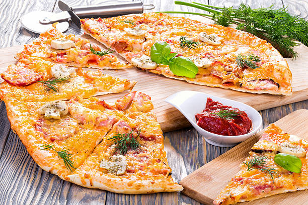 istock pizza with sausage, ham, mushrooms and cheese, close-up, macro 514565372