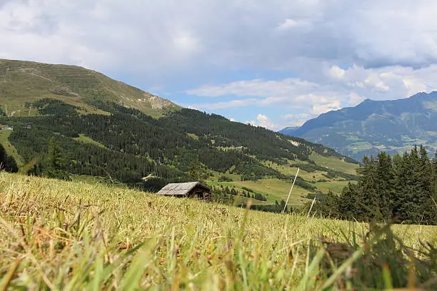 Wooden ski hut on Alp mountains with green meadow in Fiss, Tirol, Austria.