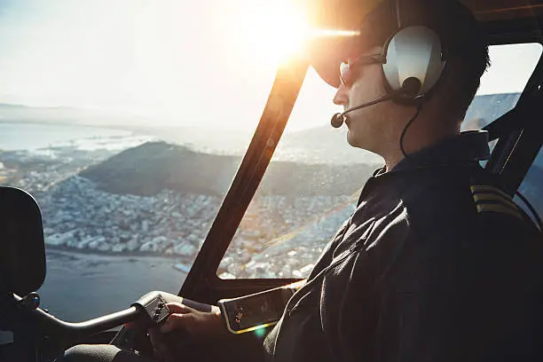 Photo of Male helicopter pilot flying aircraft