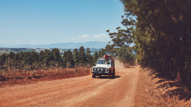 istock Car driving on country road with canoe on top 514567214