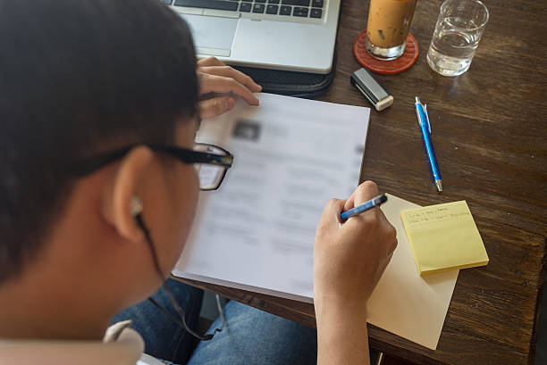 istock Asian student listenning the English question and answer into book 514568116