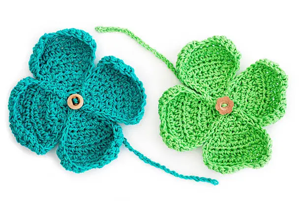 Homemade Crochet St Patricks Day Four Leaf Clovers Isolated On White.