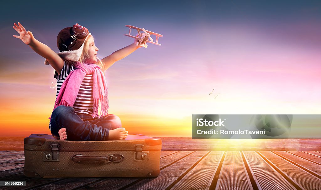 Dream journey Little Girl On Suitcase At Sunset  Child Stock Photo