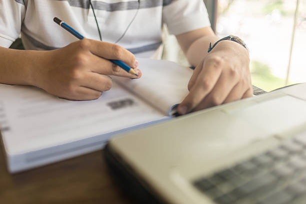 istock Close-up of man hand checking information on the book 514568620