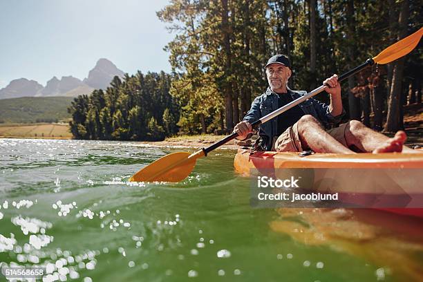 Mature Man With Enjoying Kayaking In A Lake Stock Photo - Download Image Now - Men, Mature Men, Senior Adult