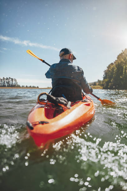 istock Mature man canoeing in a lake 514568740