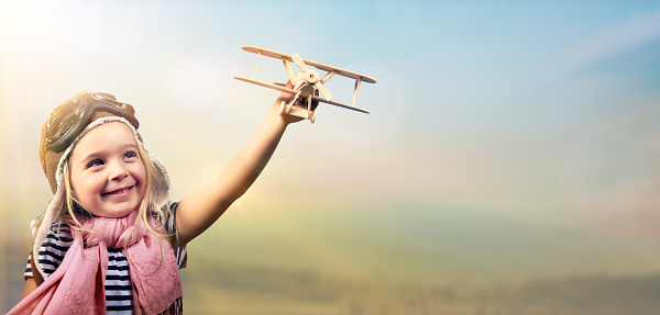 Joyful Girl Playing With Airplane Against The Sky - Vintage Effect