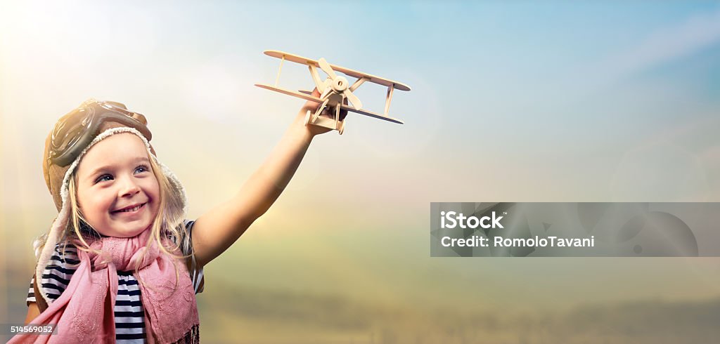 Freedom To Dream - Kid With Airplane Joyful Girl Playing With Airplane Against The Sky - Vintage Effect Child Stock Photo