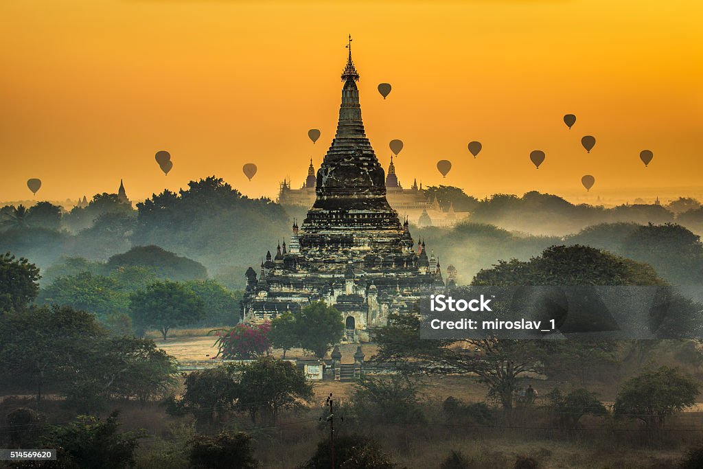 Scenic sunrise above Bagan in Myanmar Scenic sunrise with many hot air balloons above Bagan in Myanmar. Bagan is an ancient city with thousands of historic buddhist temples and stupas. Forest Stock Photo