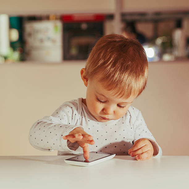 Little Boy Using Technology stock photo