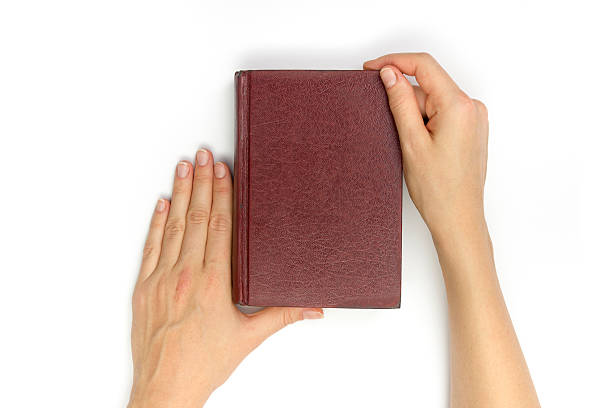 istock Hands hold blank red hardcover book on white background 514574216