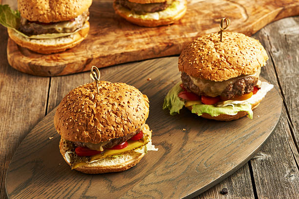 istock Home made cheeseburgers on wooden table 514574360