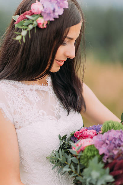 istock Lovely brunette bride with bouquet in hands close up 514574722