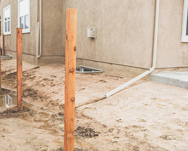 New fence construction. Fence posts cemented into ground
