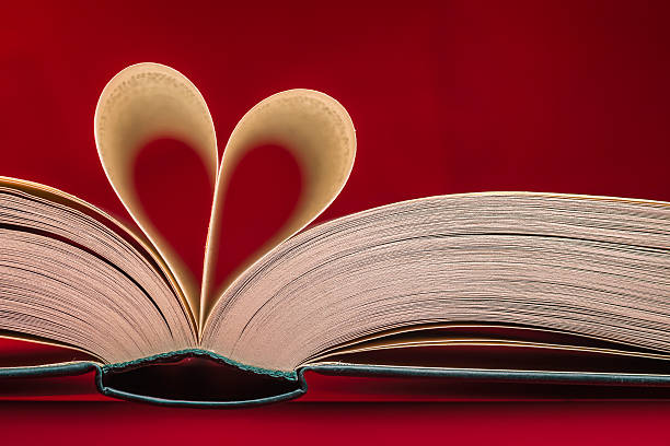 Blurry heart made from book pages over red background Blurry heart made from book pages over red background symbolism stock pictures, royalty-free photos & images