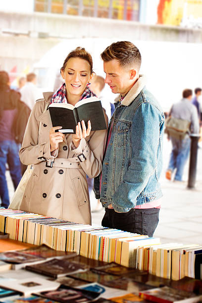 istock Young English couple looking at books on a date 514576452