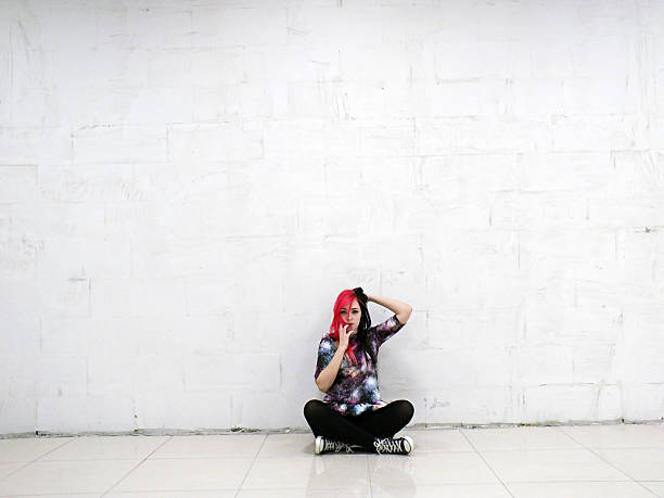 Sad girl sitting on the floor stock photo