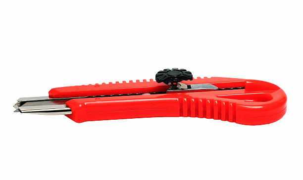 istock Red stationery knife on a white background 514579498