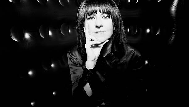istock Woman, black satin shirt, black background 514582672