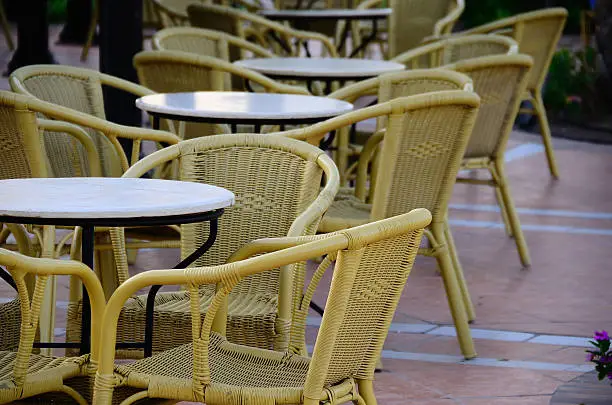 many chairs and tables at poolbar in hotel