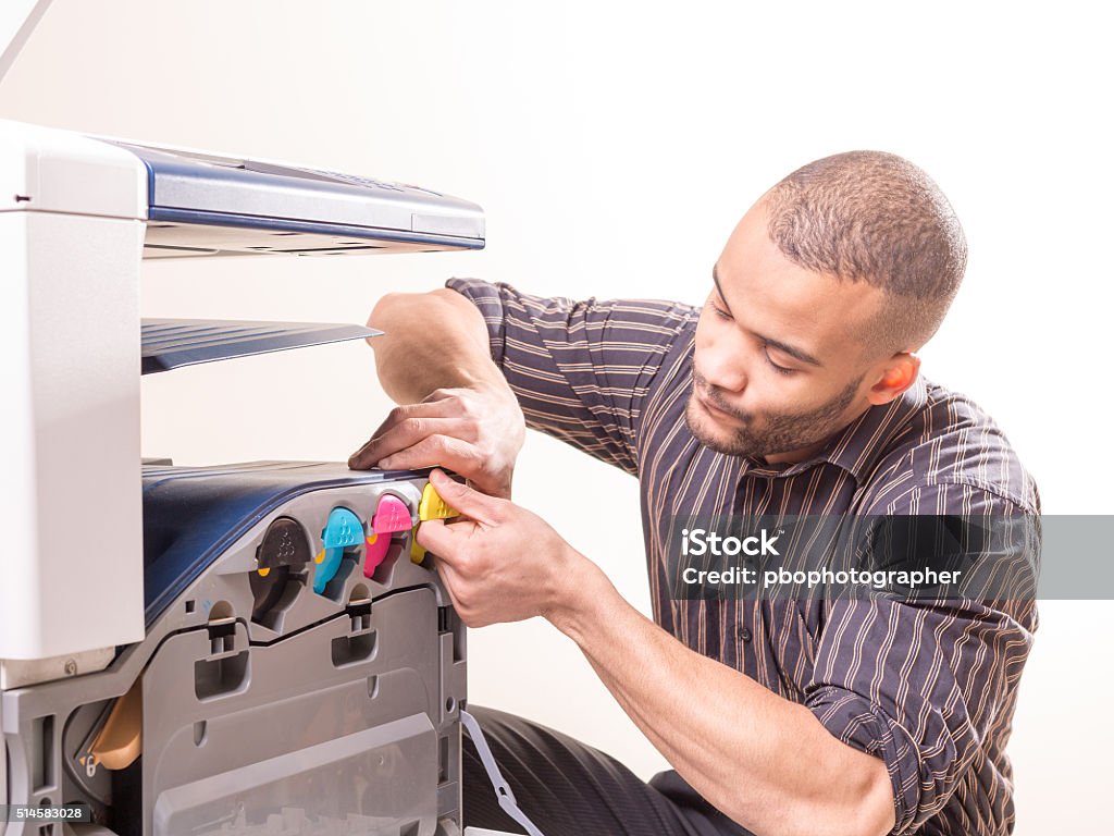 african man fixing photo copier african man making copies of documents Computer Printer Stock Photo