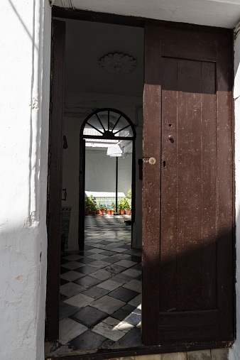 Vejer de la Frontera, Spain - August 27, 2014: Entrance and courtyard of a house in Vejer de la Frontera, a small town near Cadiz. It is placed on a hill and is characterized from white houses and small streets with great slope. 