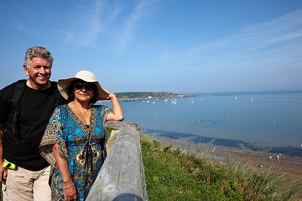 istock Mature smiling couple on grassy headland 514585705
