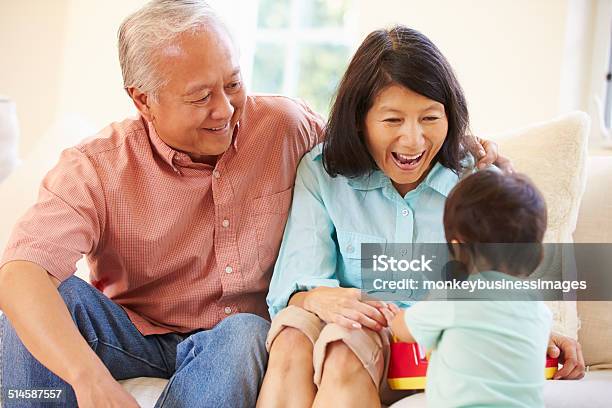 Grandparents And Grandson Playing With Toy Together Stock Photo - Download Image Now